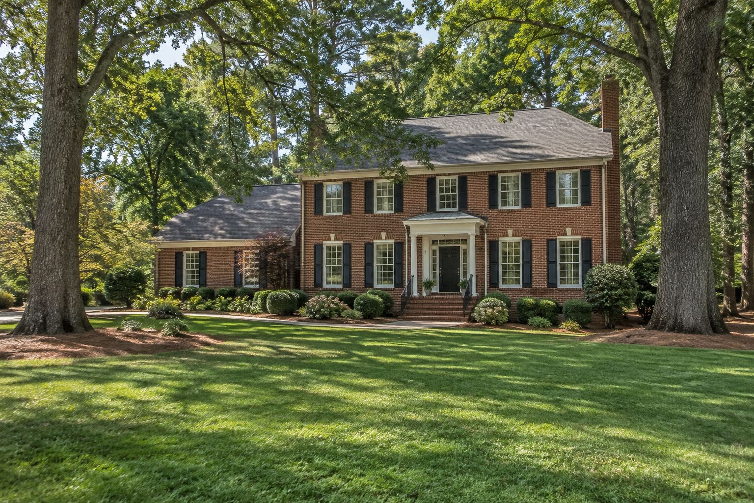 A brick colonial home in Greensboro, illustrative